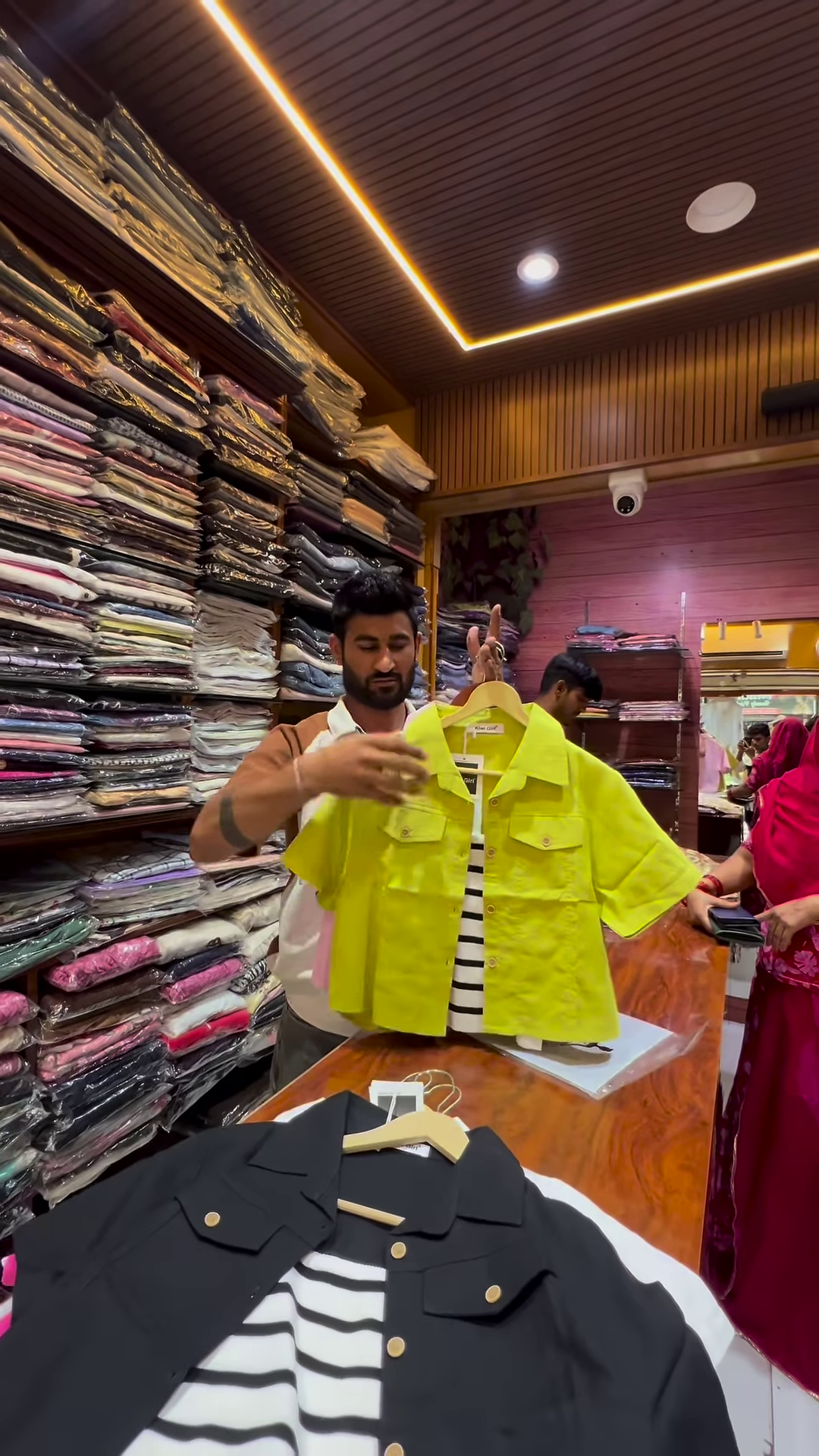 White Buttoned Utility Jacket with Chest Flap Pockets over Striped Inner Layer - Image 3