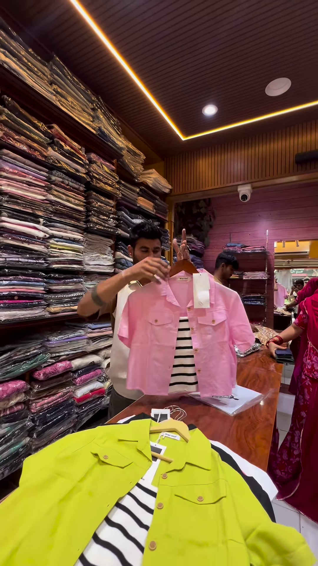 White Buttoned Utility Jacket with Chest Flap Pockets over Striped Inner Layer - Image 2