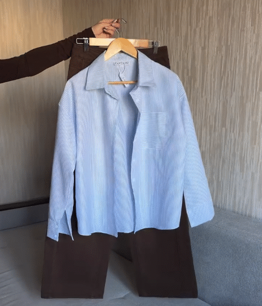 👚 Women’s Blue & White Vertical Striped Oversized Shirt Paired with Dark Brown Trousers | Effortless Chic Smart-Casual Outfit