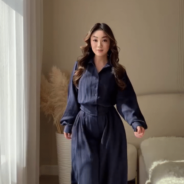 💙 Woman in Navy Blue Long-Sleeved Wide-Leg Jumpsuit – Elegant Modern Power Dressing Look